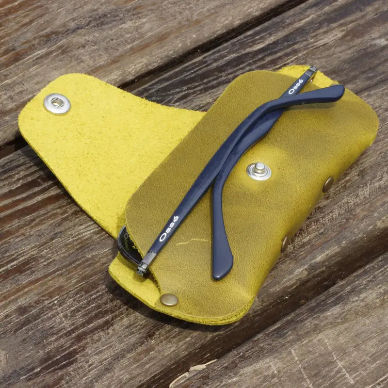 Blue eyeglass frames in a Premium Leather Eyeglass & Sunglasses Case with yellow leather finish