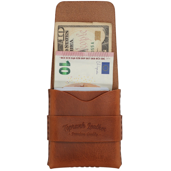 An open camel full grain leather strap wallet with a banknote lying flat in the full-length compartment