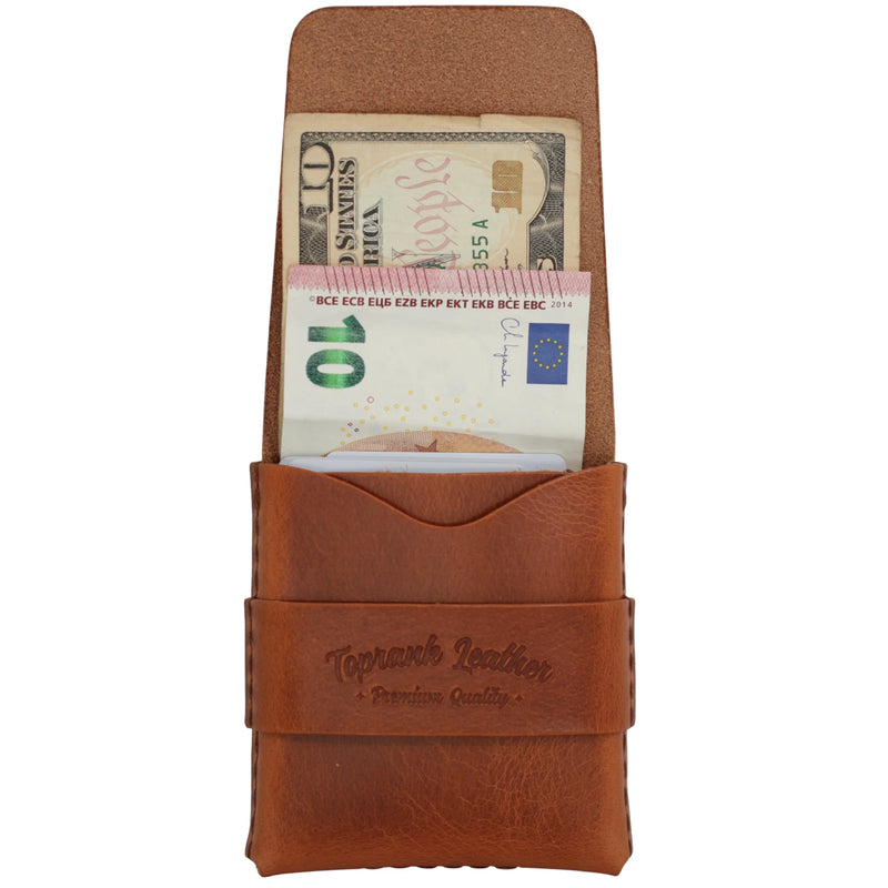 An open camel full grain leather strap wallet with a banknote lying flat in the full-length compartment