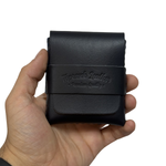 Hand holding a black leather wallet with 'Top Grade Leather' branding on a white background 