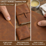 Three-panel close-up collage showing a brown leather notebook and wallet with a finger rubbing the surface to demonstrate a vintage patina and waxed finish. Text at the top reads 'CRAZY HORSE CHARACTER' and the bottom text explains that a light scratch lifts the wax, with many makers loving that vintage character and others preferring it clean. 