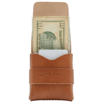 Brown leather money clip with a dollar bill inside on a white background 