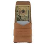 Brown leather money clip with a dollar bill on a white background 
