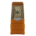 Orange leather wallet with a dollar bill inside on a white background 