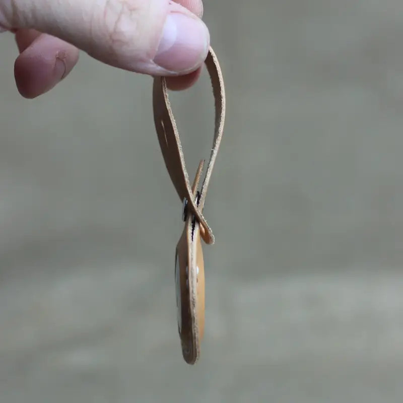 Handcrafted full-grain leather Airtag holder with loop and secure snap-button closure