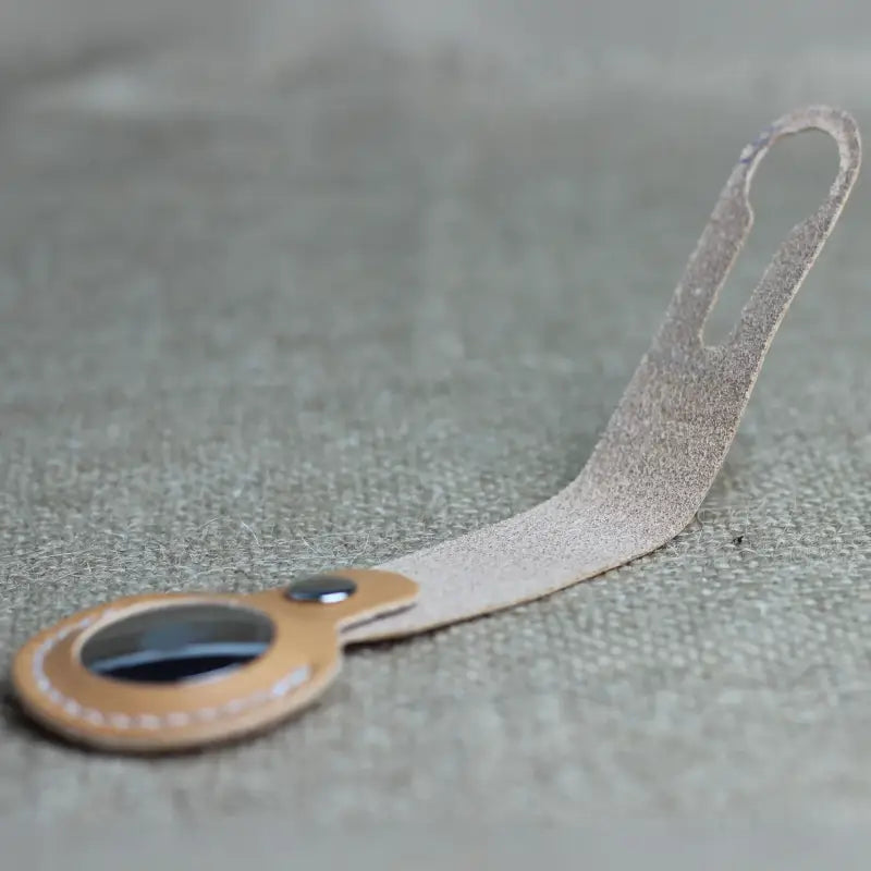 Handcrafted full-grain leather Airtag holder with loop and secure snap-button closure