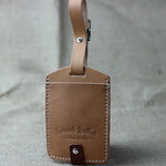 Tan leather luggage tag for travel, customizable leather luggage tag for stylish journeys