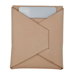 A light brown kraft paper envelope-style sleeve with a diagonal flap closure, shown on a plain white background. A white rectangular card is partially visible inside the top flap. 