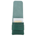 Green leather case with a white interior holding a gold item on a white background 