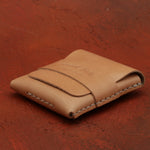 Brown leather wallet on a red textured surface 