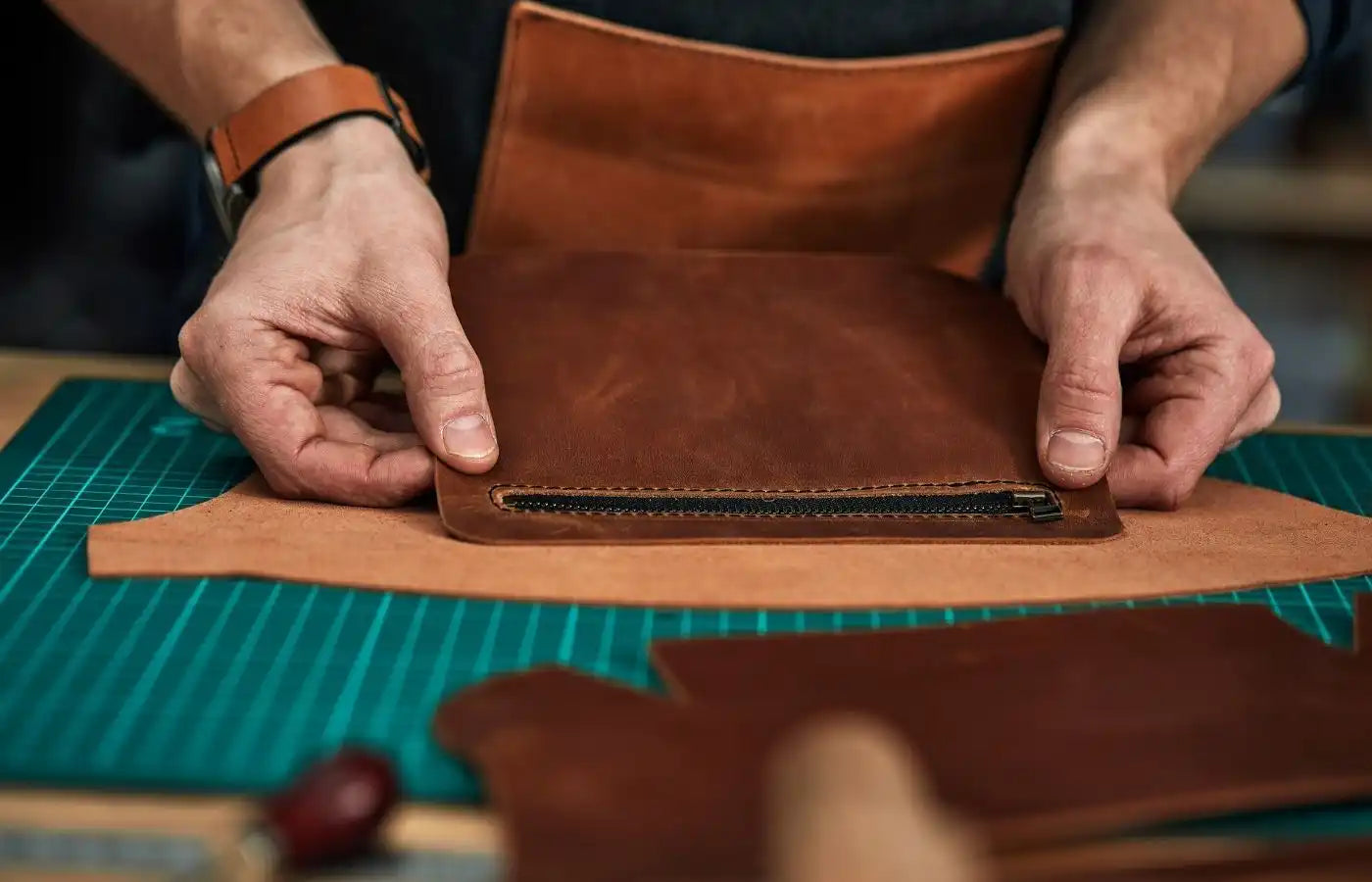 Handcrafted brown leather pouch with zipper.