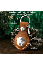 Leather airtag holder with keychain ring on a wooden surface with greenery in the background 