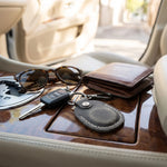 Keys, sunglasses, and wallet on a car's dashboard 