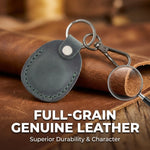 Leather keychain with magnifying glass on a brown leather surface, text 'Full-Grain Genuine Leather' displayed. 