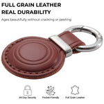Brown leather keychain with silver ring on a white background, featuring text about full grain leather durability. 