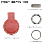 Collection of keychain components including a leather Air Tag holder, steel loop, quick-clip carabiner, and key rings on a white background. 