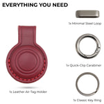 Red leather Air Tag holder with minimal steel loop, quick-clip carabiner, and key ring on a white background. 