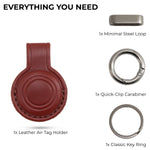Collection of keychain components including a leather Air Tag holder, steel loop, quick-clip carabiner, and key rings on a white background. 