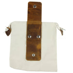 Canvas pouch with leather strap and metal clasps on a white background 