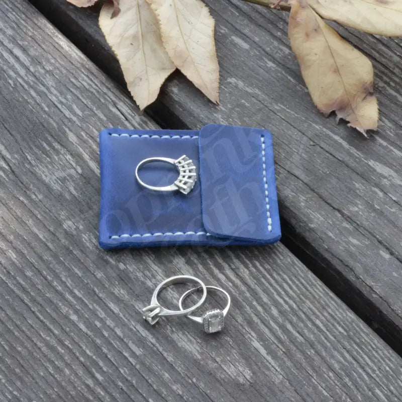 Leather Wedding Ring Case showcasing elegant jewelry on a blue leather holder