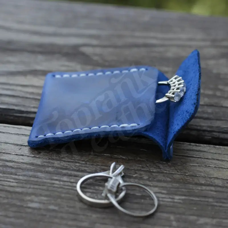 Blue leather wedding ring case with rings for elegant jewelry storage