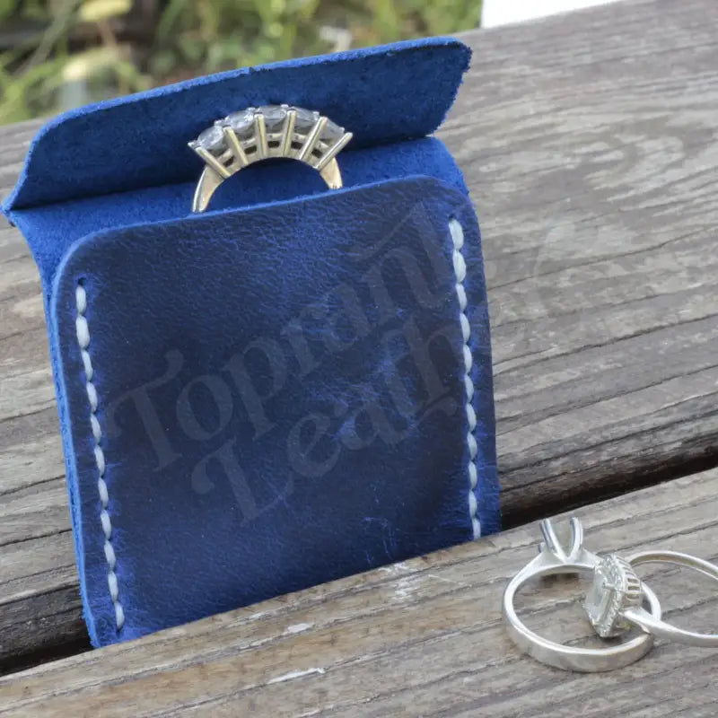 Blue leather ring holder in a stylish Leather Wedding Ring Case for elegant storage