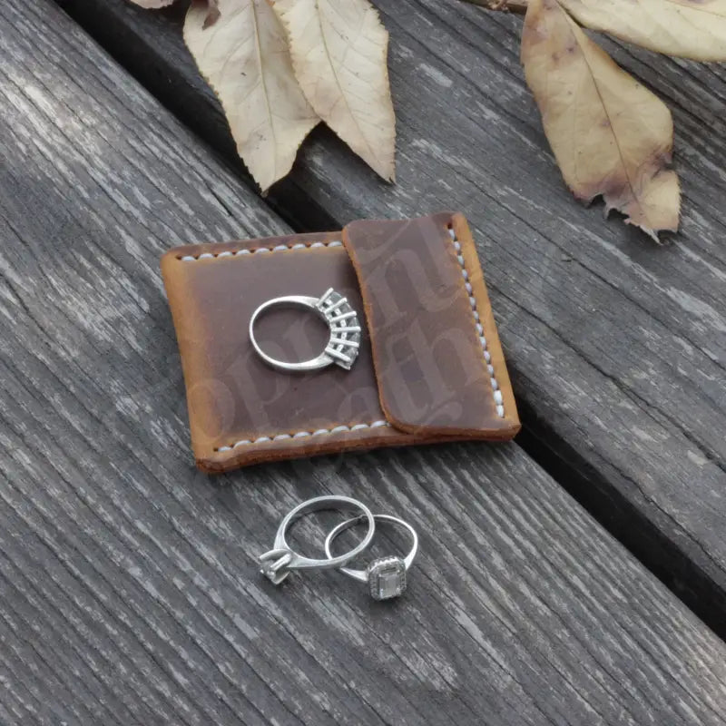 Leather wedding ring case displaying a stylish leather ring holder with elegant rings