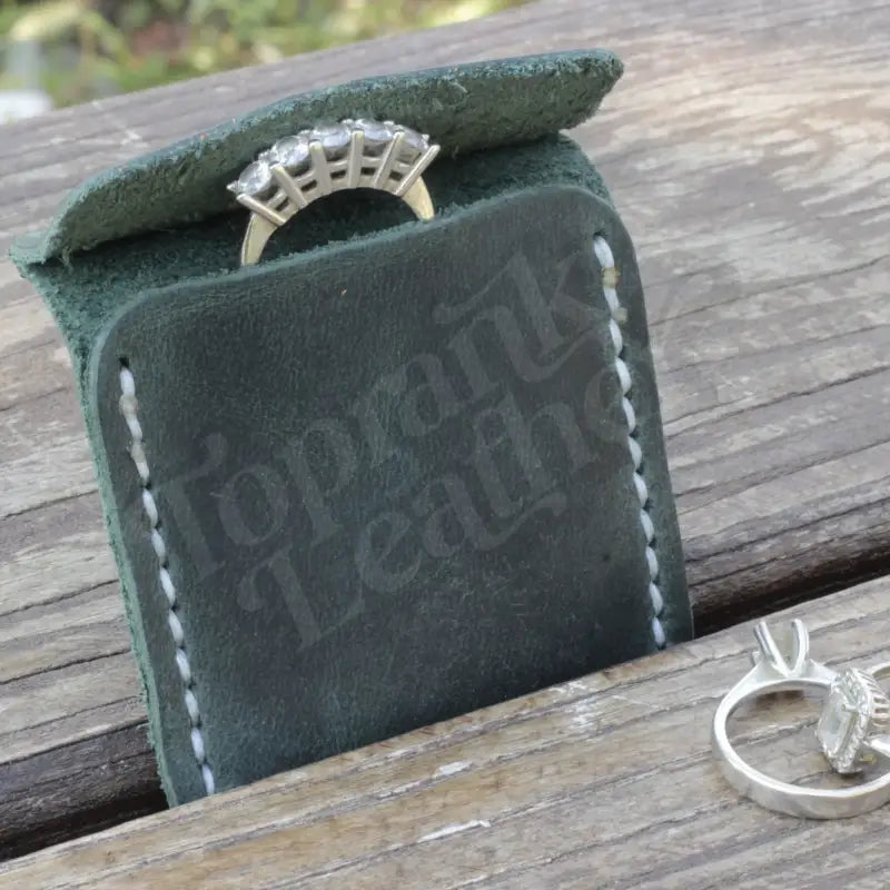 Green leather wedding ring case designed for elegant jewelry storage and display