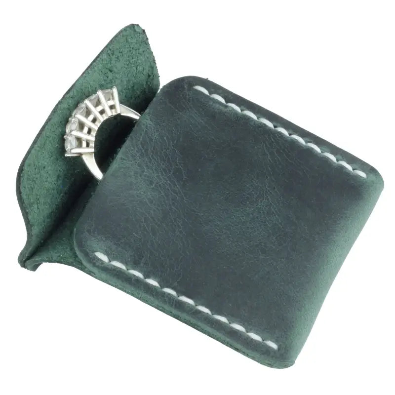 Diamond ring in leather pouch inside a stylish Leather Wedding Ring Case for secure storage