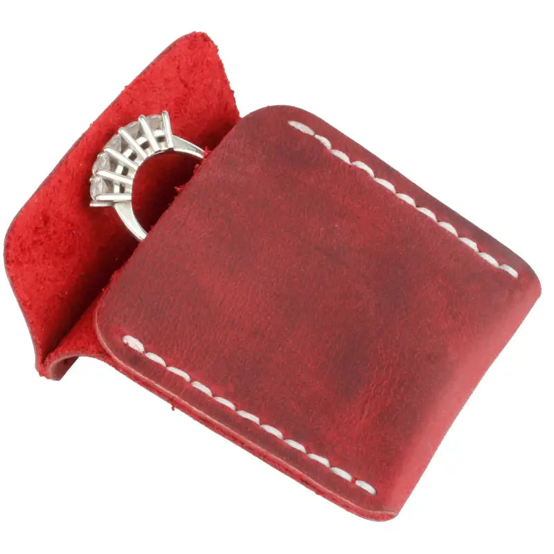 Red leather wedding ring case with white stitching for elegant jewelry storage