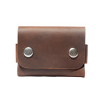 Handcrafted full-grain tan leather cardholder with a minimalist snap button closure for durability and style.