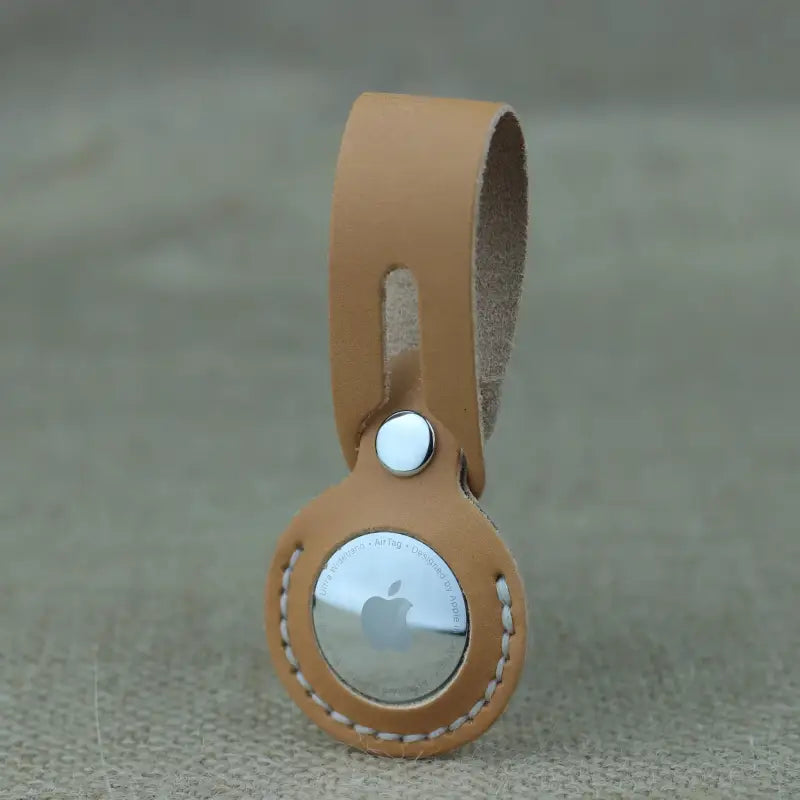Handcrafted full-grain leather airtag holder with secure snap-button closure for keys