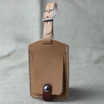 Premium Leather Luggage Tag in tan color, featuring a sleek and durable handcrafted design for secure travel identification.