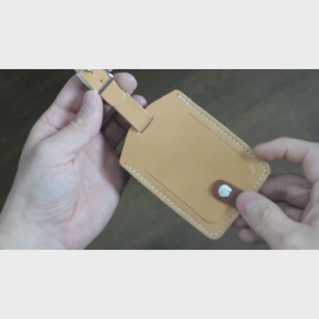 A close-up video showcasing the Leather Luggage Tag, highlighting its full-grain vegetable-tanned leather, hand-stitched craftsmanship, and customizable engraving options.