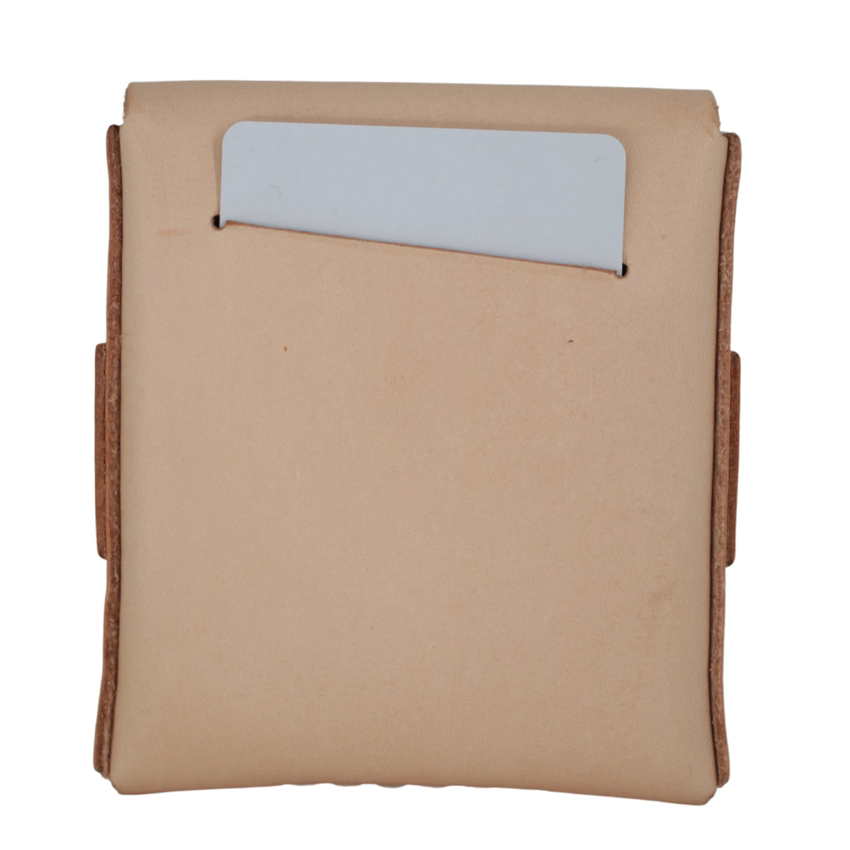 A tan leather card holder or wallet with a vertical slot containing a light gray card, shown against a plain white background. 