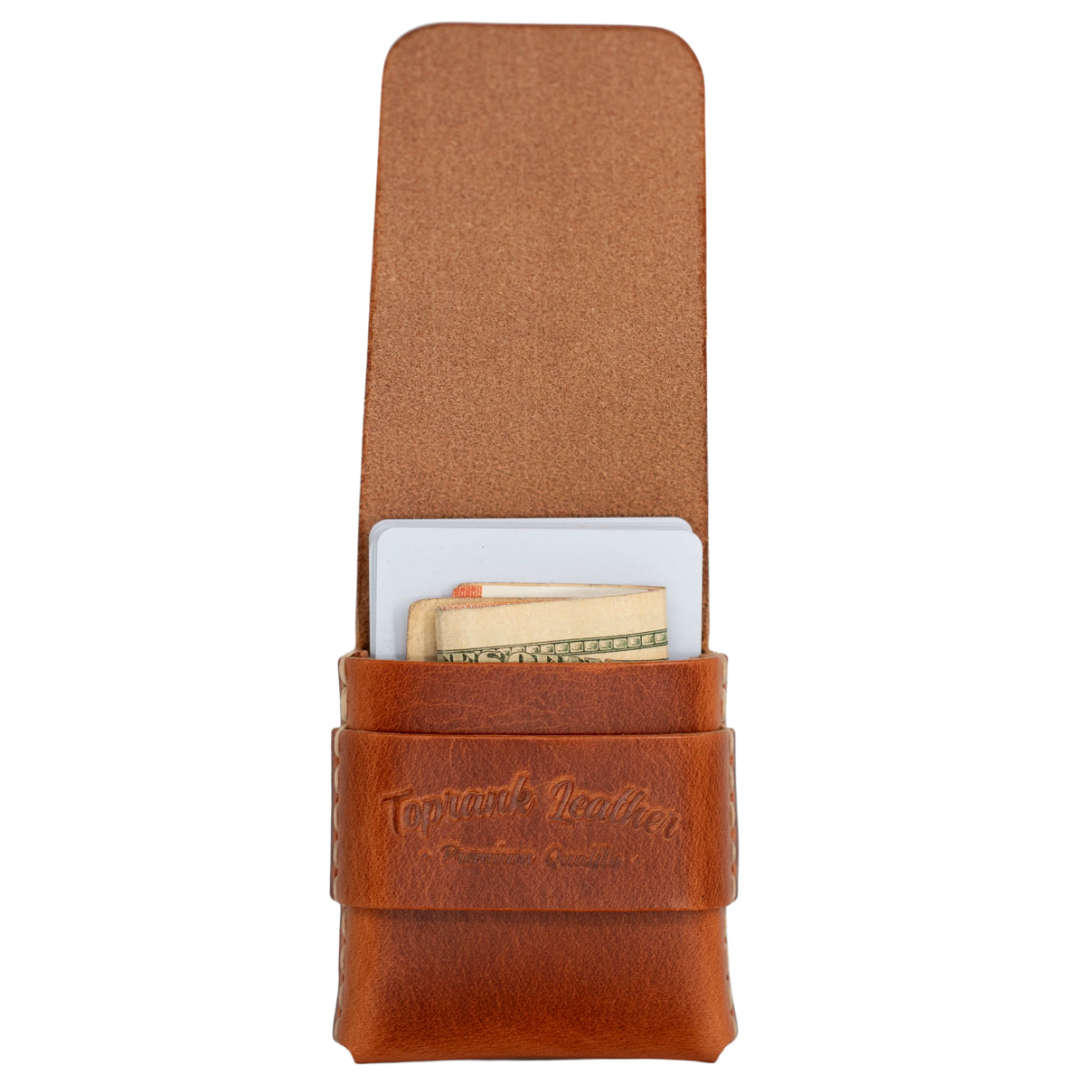 A brown leather card holder wallet with a strap closure, shown open with cards and cash partially visible inside. The leather has an embossed logo reading 'Tough Made Leather' on the front strap. 
