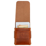 A brown leather card holder wallet with a strap closure, shown open with cards and cash partially visible inside. The leather has an embossed logo reading 'Tough Made Leather' on the front strap. 