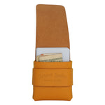 An open tan leather card holder or wallet with a strap closure, showing a card and cash inside, on a plain white background. The strap is embossed with the brand name 'Topmark Leather'. 
